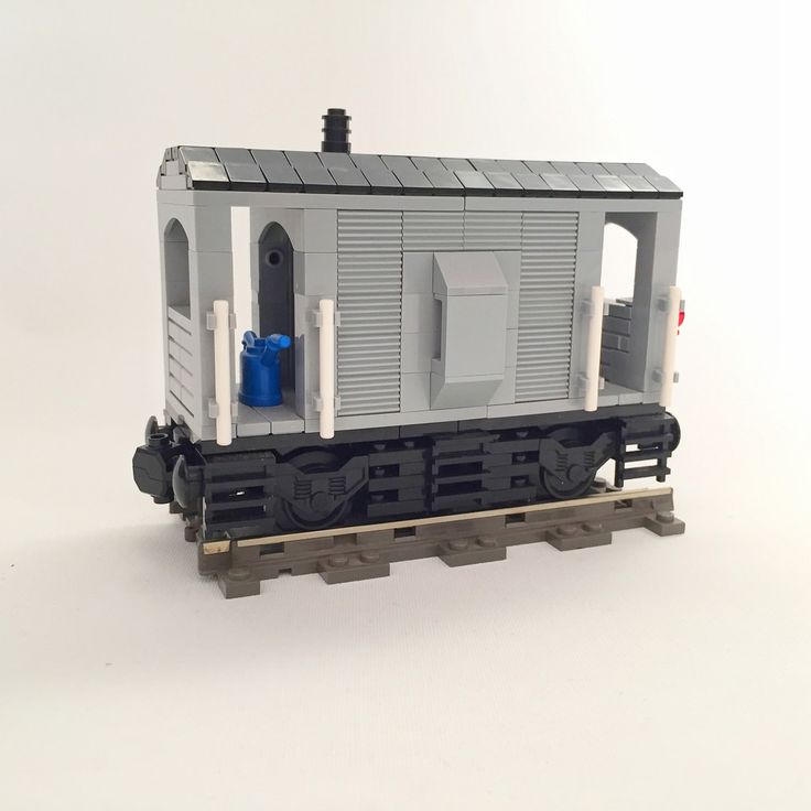 a toy train car sitting on the tracks