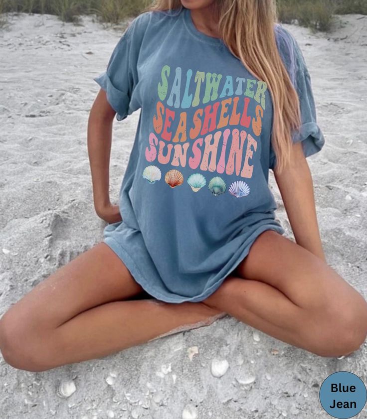 🌊Discover our Retro Summer Beach, Saltwater, Seashells, Sunshine Comfort Colors shirt!🏝️ This trendy unisex t-shirt is designed to enhance your beach vibes and have you dreaming of your next beach vacation! Featuring an eye-catching vintage design, this shirt is super soft and comfortable made of 100% ring-spun ethically grown cotton. It has a relaxed fit that is made of a medium fabric that is preshrunk. Looks super cute with shirts, jeans or size up for an oversized beach cover up. Great gif Fun Summer T-shirt For Beach Party, Casual Blue T-shirt For Beach Party, Blue Short Sleeve T-shirt For Beach Season, Blue Summer T-shirt For Vacation, Blue Short Sleeve T-shirt For Beach, Blue Short Sleeve Summer T-shirt, Fun Beach Party T-shirt With Letter Print, Beachy Summer T-shirt With Funny Print, Beachy Funny Print Summer T-shirt