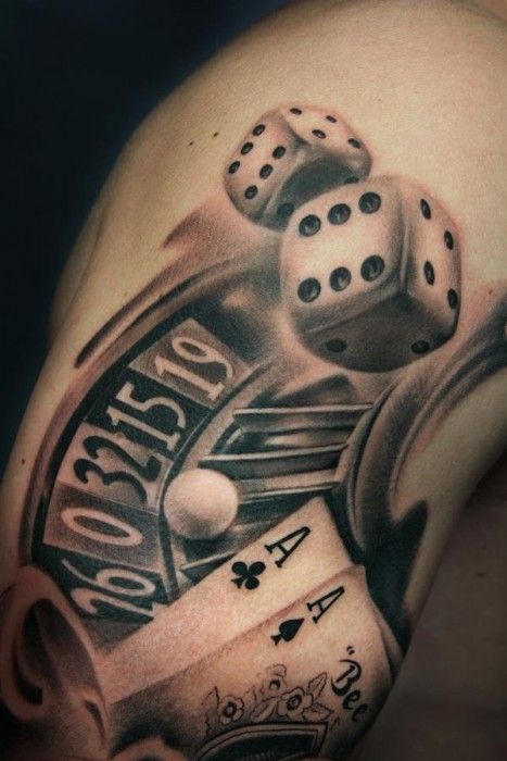 a man's arm with dice and playing cards on it