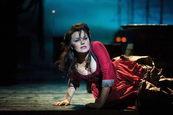 a woman is laying on the ground in red