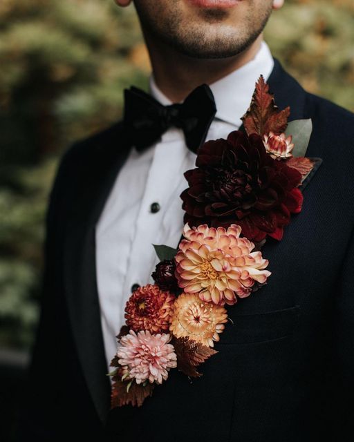 a man in a tuxedo with flowers on his lapel