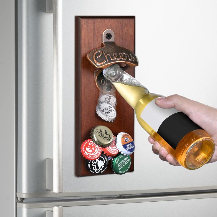 a person is opening a bottle opener on a refrigerator