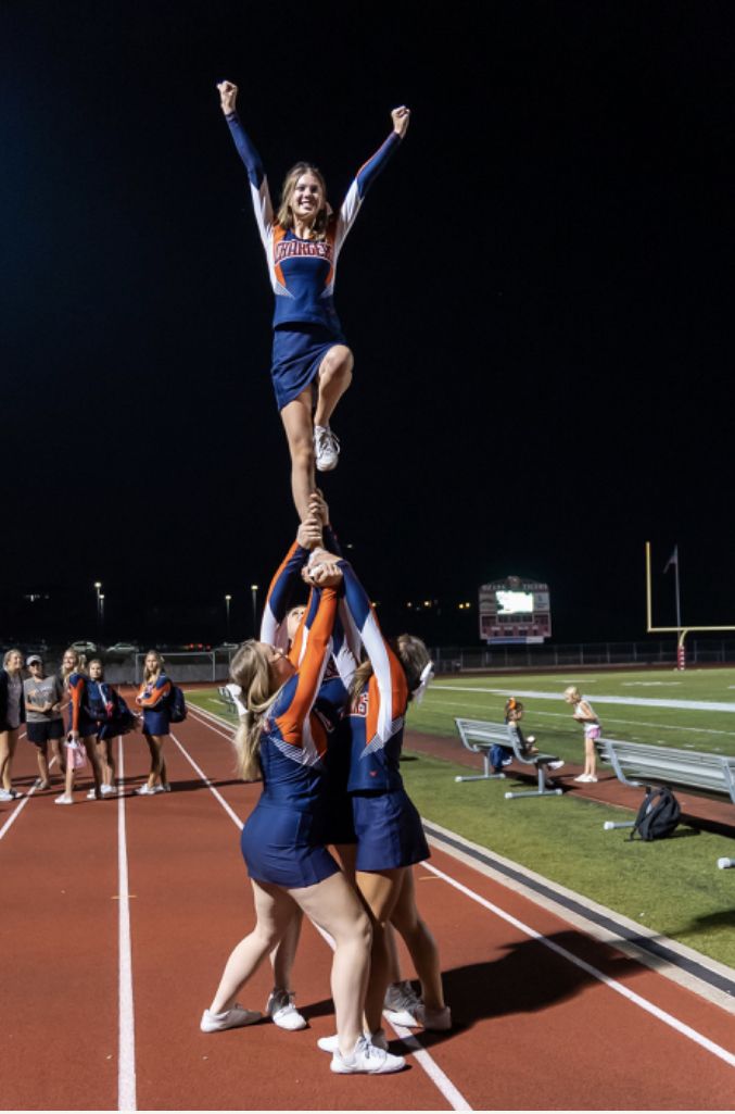 the cheerleaders are doing tricks on the track