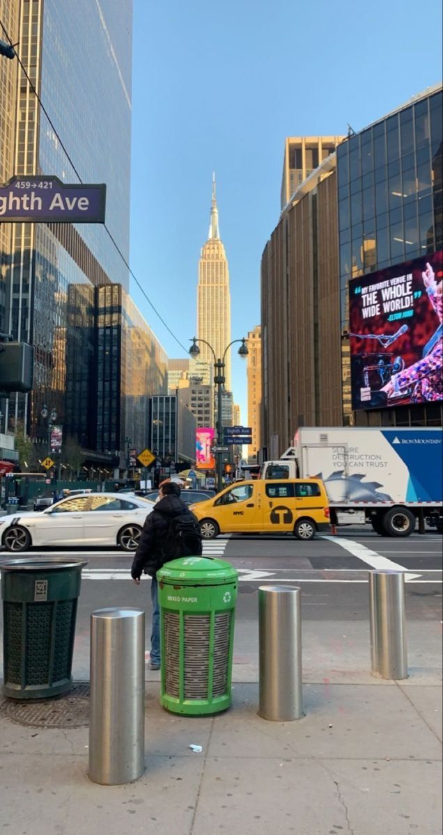 a person sitting on a bench in the middle of a city