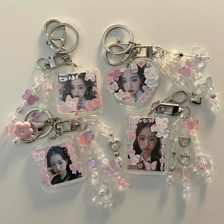 four key chains with pictures and pearls hanging from them