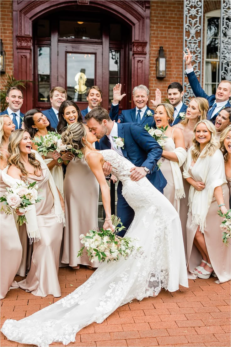 a bride and groom are surrounded by their bridal party