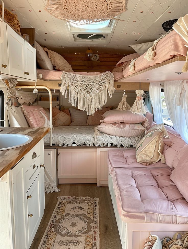 the inside of a camper with pink furniture and decor on it's walls