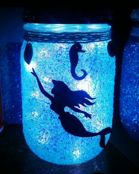 there is a jar with some glitter in it and a seahorse on the lid