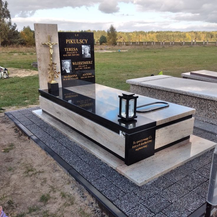 a monument with a cross and plaque on it