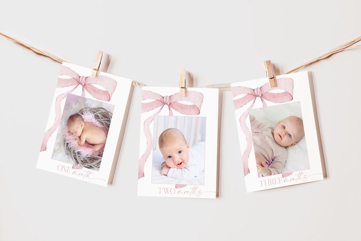 three baby photos hanging on clothes pins with pink bows and twine around the photo