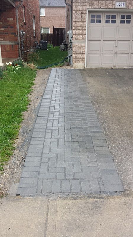 a fire hydrant sitting in the middle of a driveway