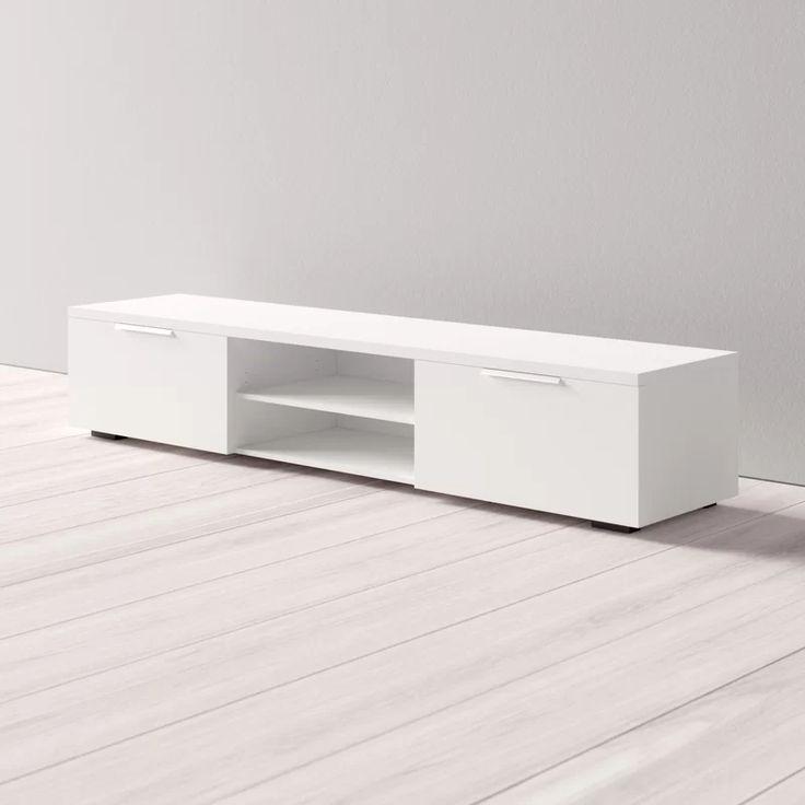 a white entertainment center with two drawers on the bottom and one door open to reveal an empty room