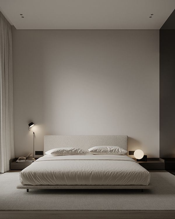 a large white bed sitting in a bedroom next to two lamps on either side of the bed