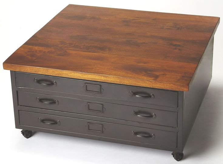 a wooden table top sitting on top of a metal drawer