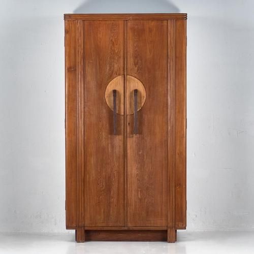 an old wooden cabinet with two doors on the front and one door in the back