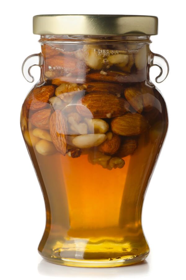 a jar filled with lots of nuts sitting on top of a table