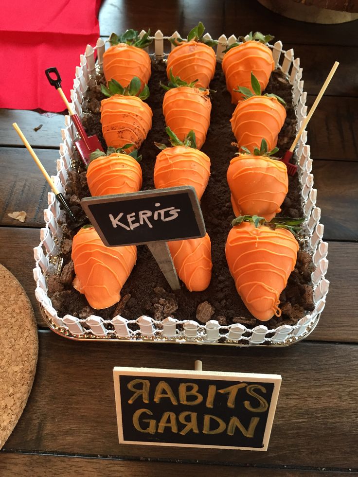 carrots are arranged on sticks in a tray