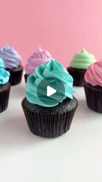 several cupcakes with different colored frosting on them