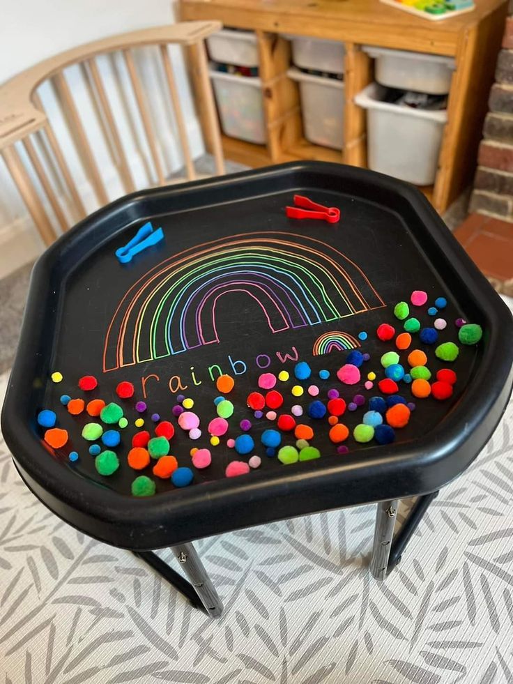 a child's chalkboard table with lots of colored sprinkles on it