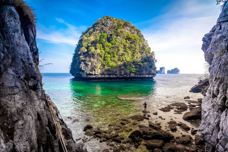 an island in the middle of water surrounded by rocks