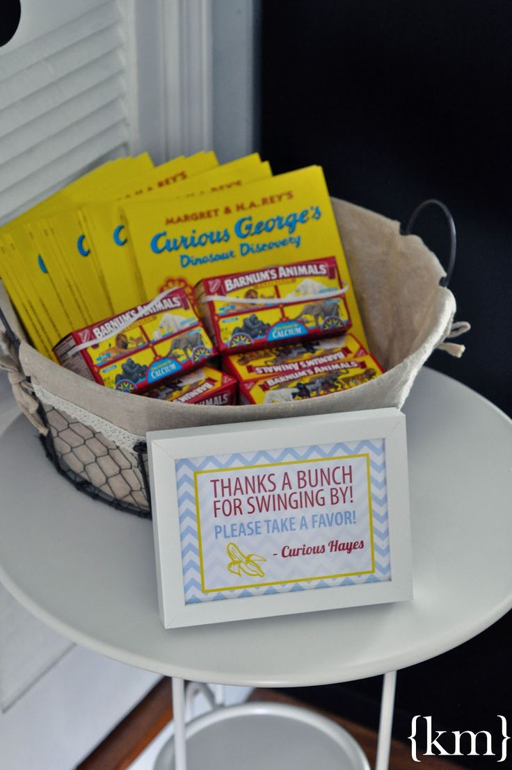 a basket filled with candy sitting on top of a table next to a sign that says, thank a bunch for swinging by