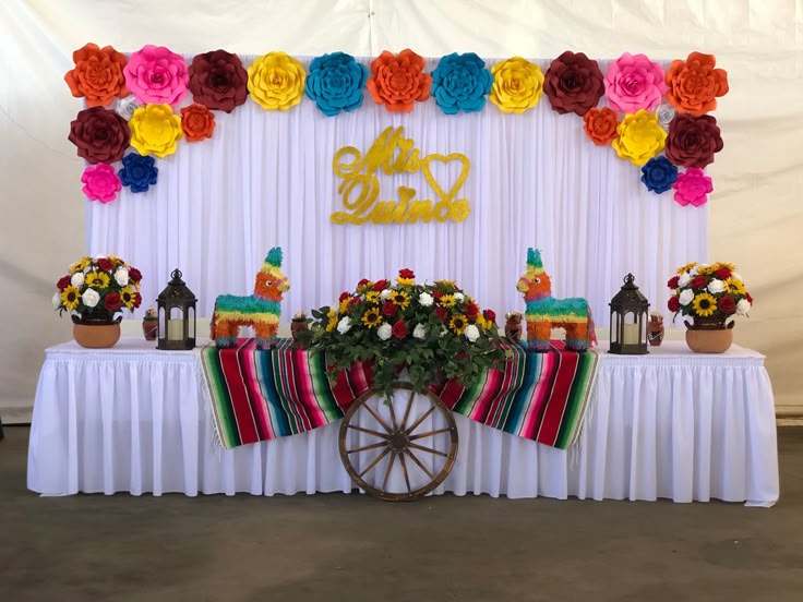 a decorated table with flowers and decorations on it