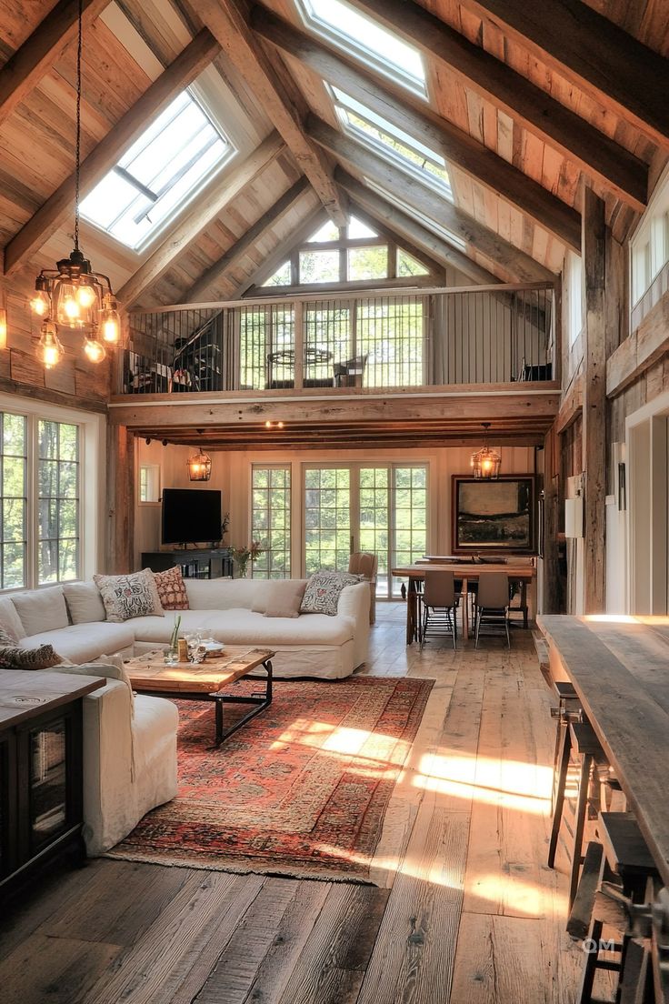 a living room filled with lots of furniture and wooden floors covered in windows next to a dining table