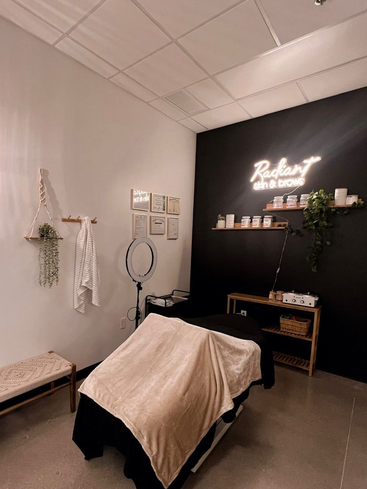 a room with a bed, table and shelves on the wall that have items on it