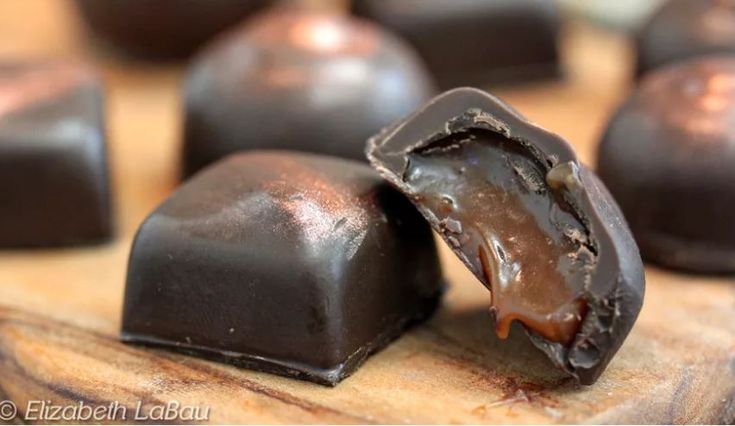 some chocolates are sitting on a cutting board