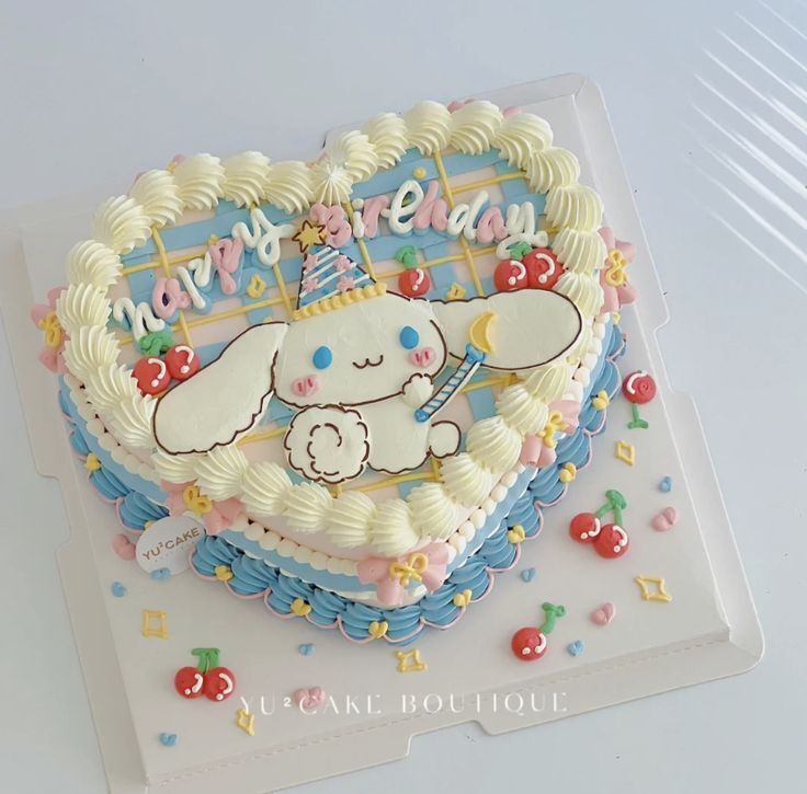 a heart shaped birthday cake with an elephant on it