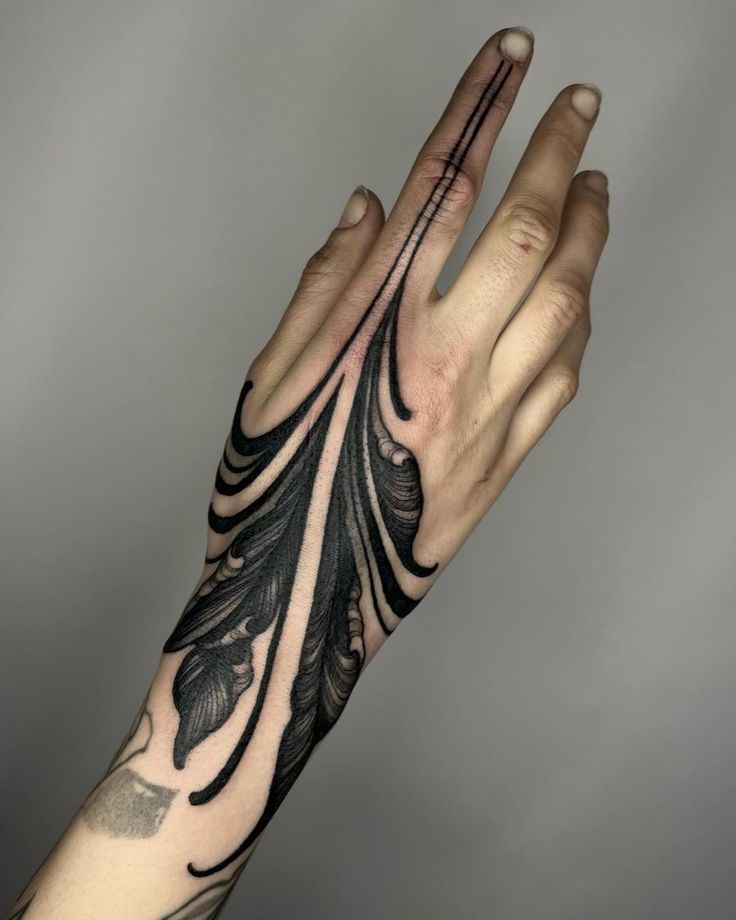 a person's arm with black ink on it and an intricate design in the middle