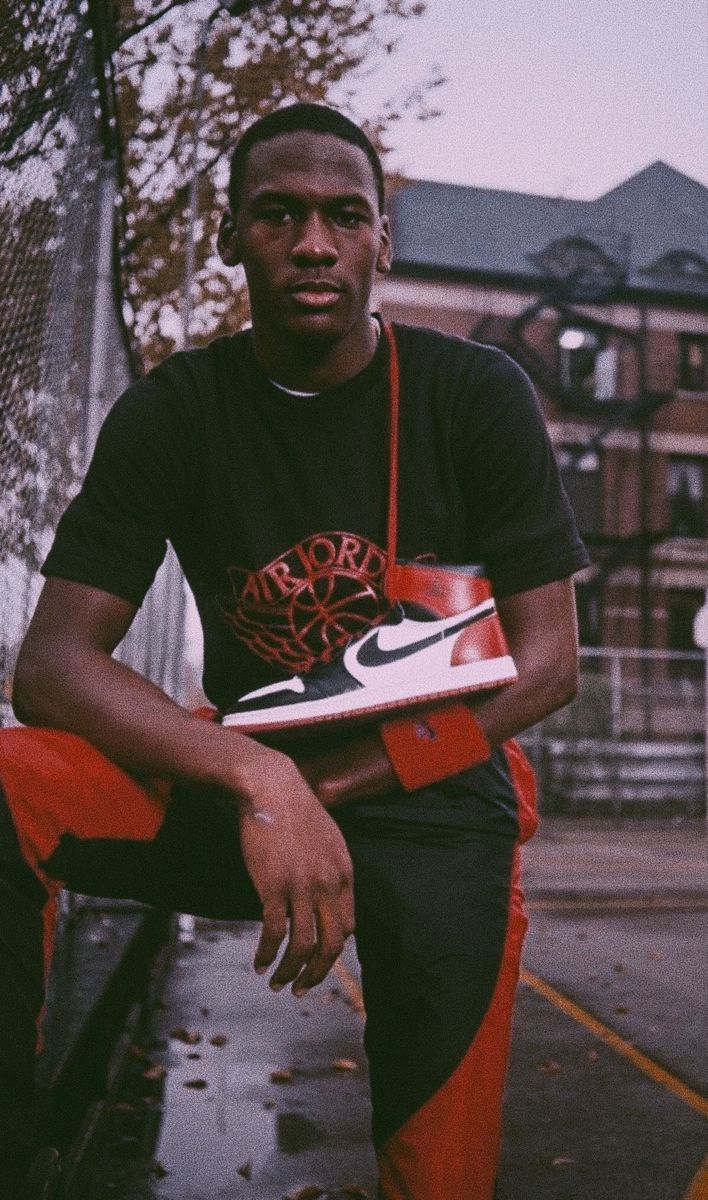 a man sitting on a bench holding a shoe