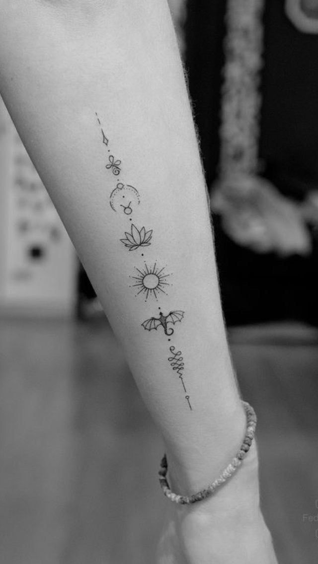 black and white photo of a woman's foot with tattoos on it, including flowers