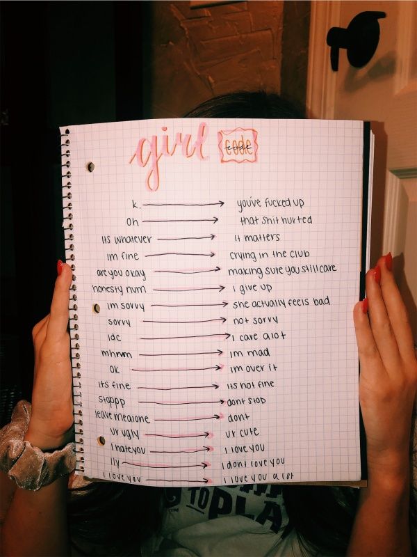 a person holding up a notebook with the words girl boss written on it in front of their face