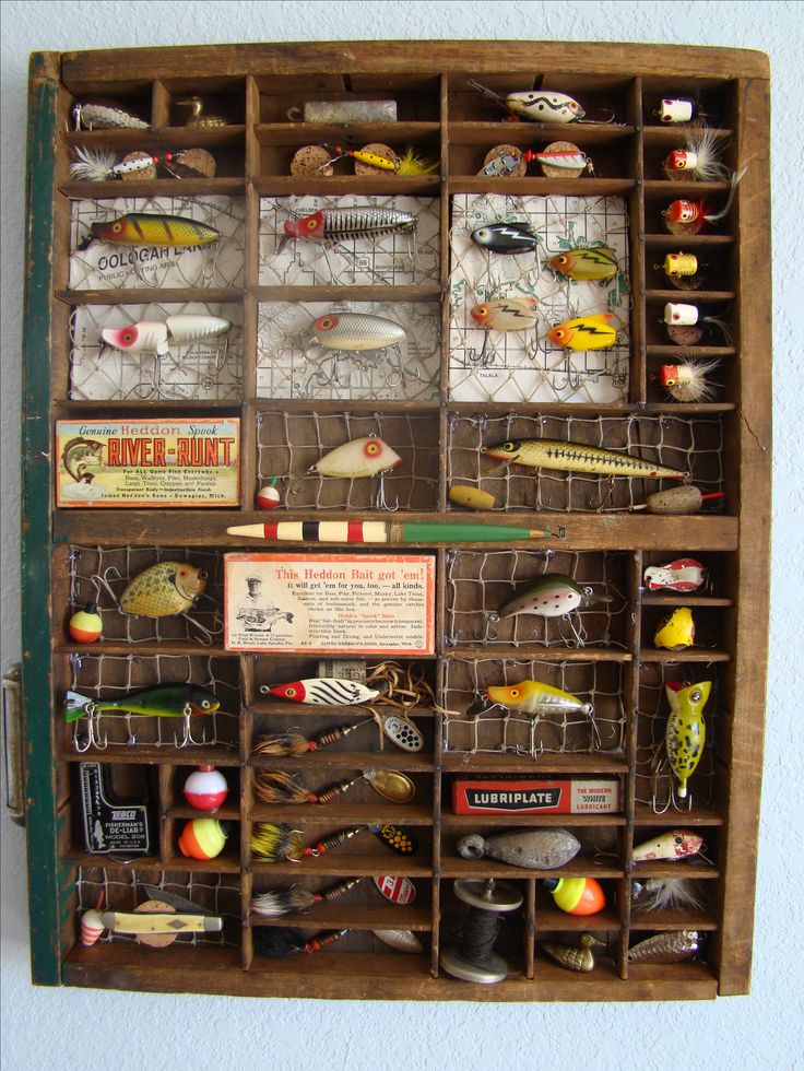 a wooden box filled with lots of different types of fishing lures