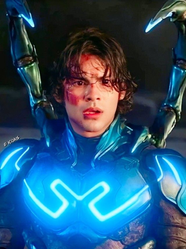 a young man in a futuristic suit with blue lights on his hands