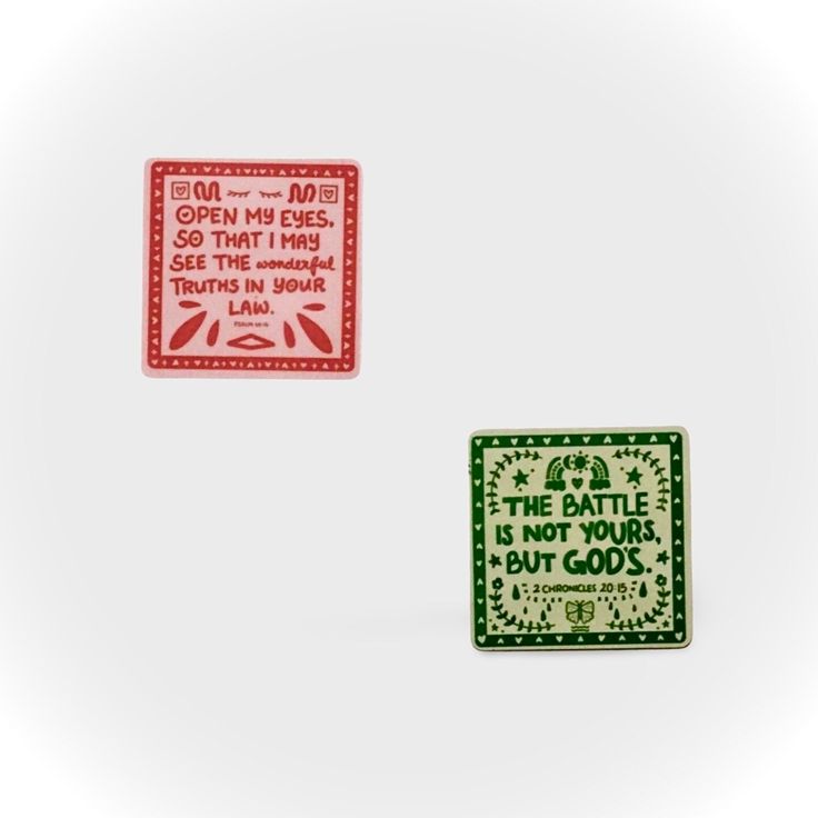 two red and green square stickers with the words, the battle is not your but god's