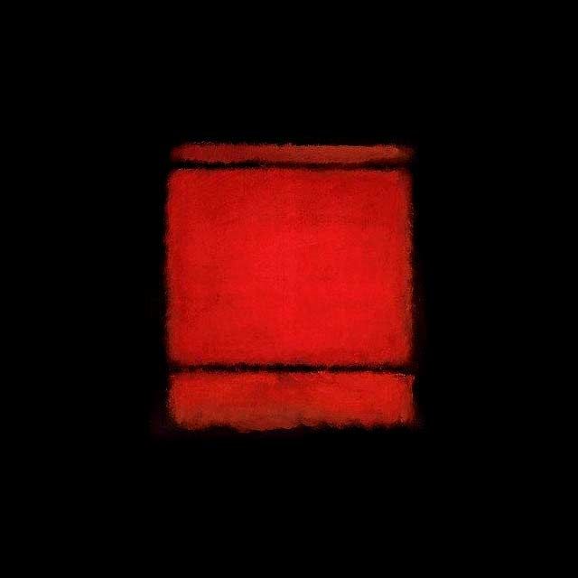 a red square in the middle of a black background