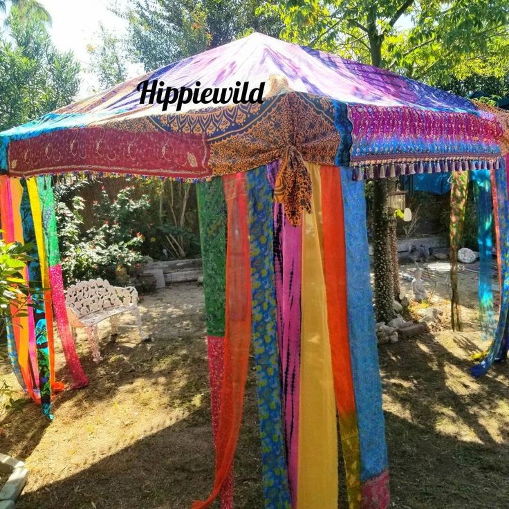 a colorful tent with ribbons hanging from it's sides and the words hippiewuld above it