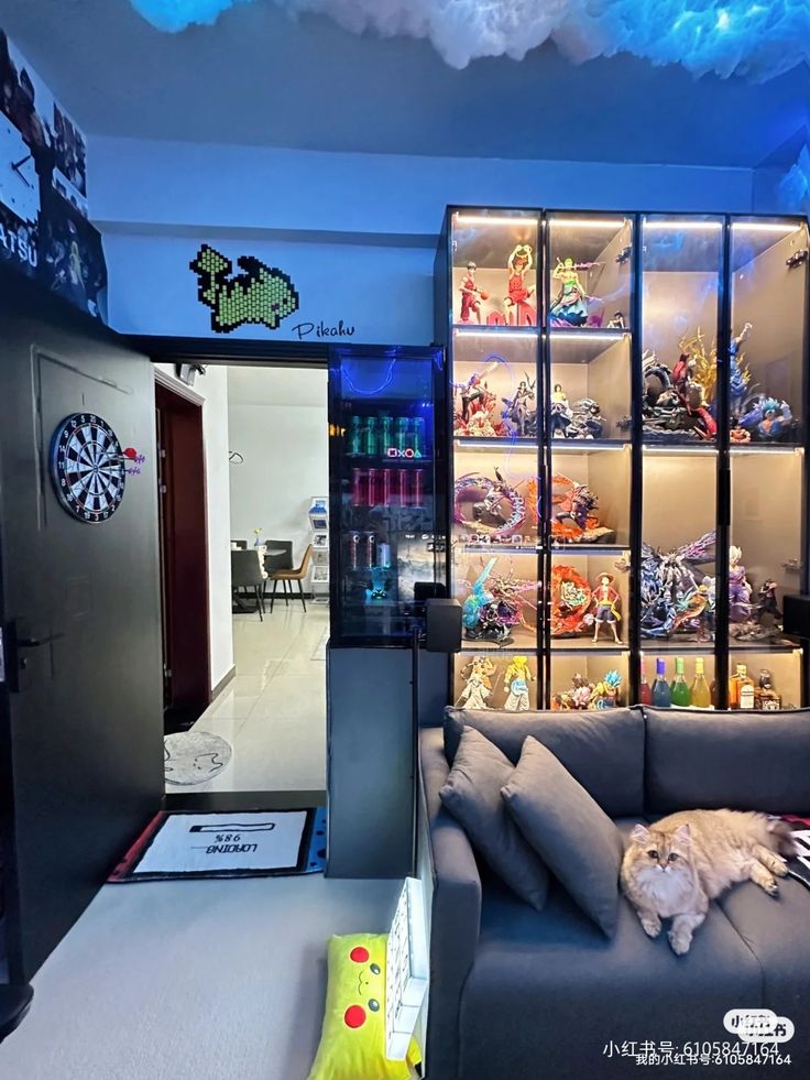 a living room filled with lots of furniture and shelves full of toys on display behind glass doors