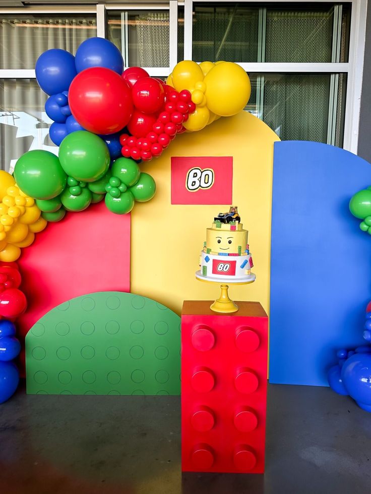 a lego themed birthday party with balloons and cake