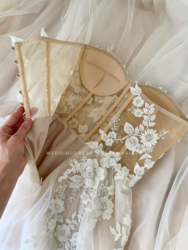 a woman is holding an umbrella over her wedding dress