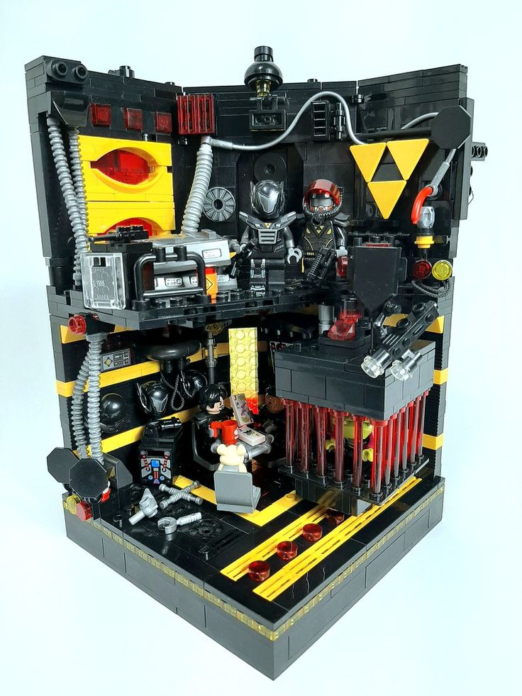 a lego model of a work station with various tools and equipment in the center, on a white background