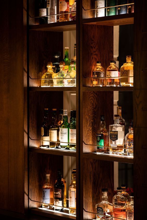 the shelves are filled with different types of liquor