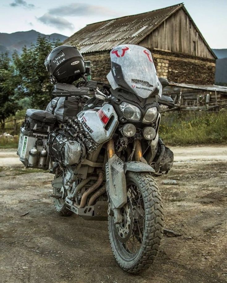 a motorcycle parked in front of a barn