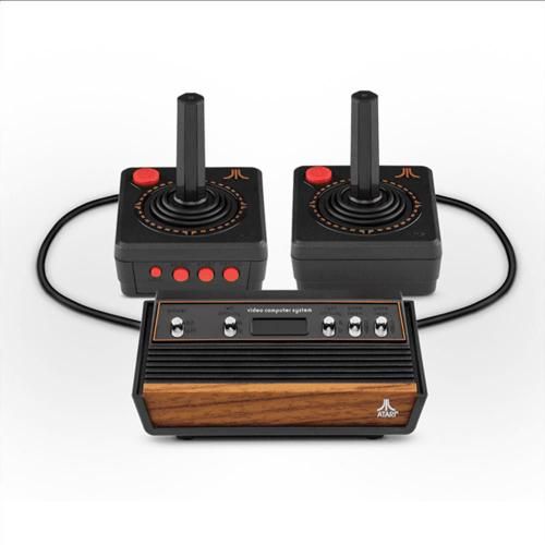 two old school video game controllers sitting next to each other