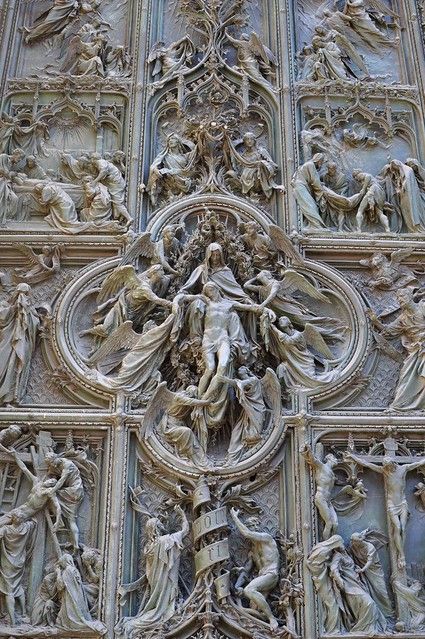 an intricately carved door with statues on it