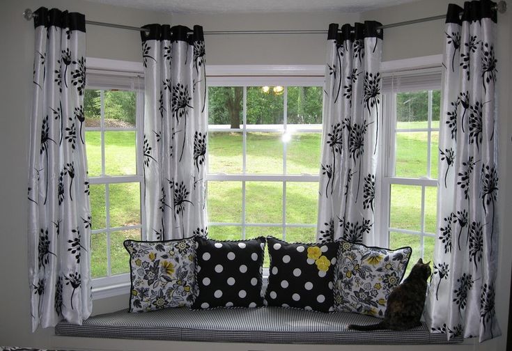 a black and white window seat with polka dot pillows