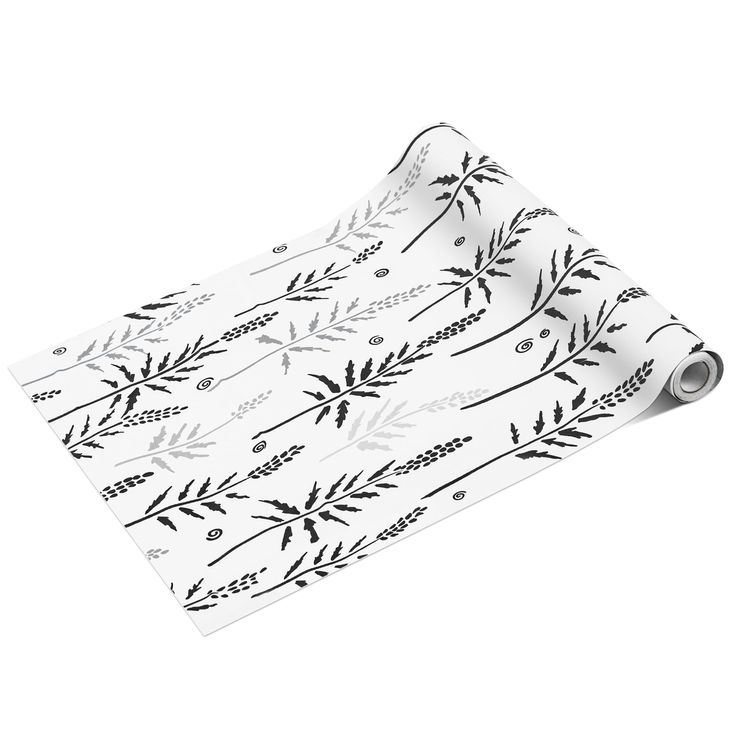 a white wrapping paper with black leaves on it