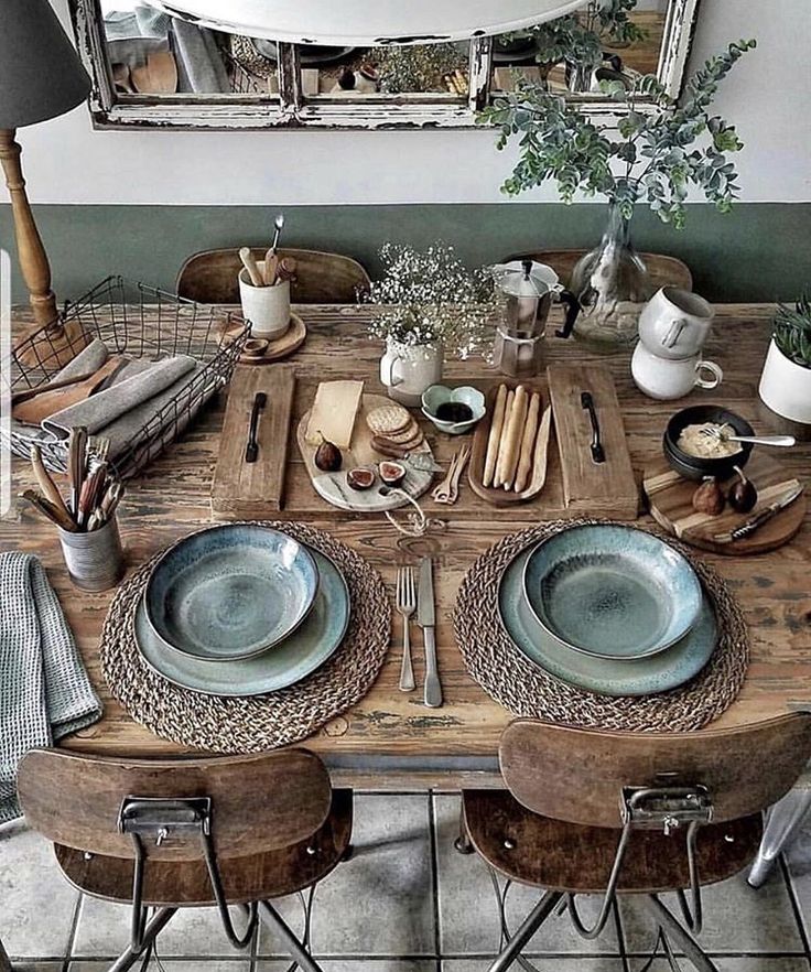 the table is set with dishes and place settings for four people to eat at it